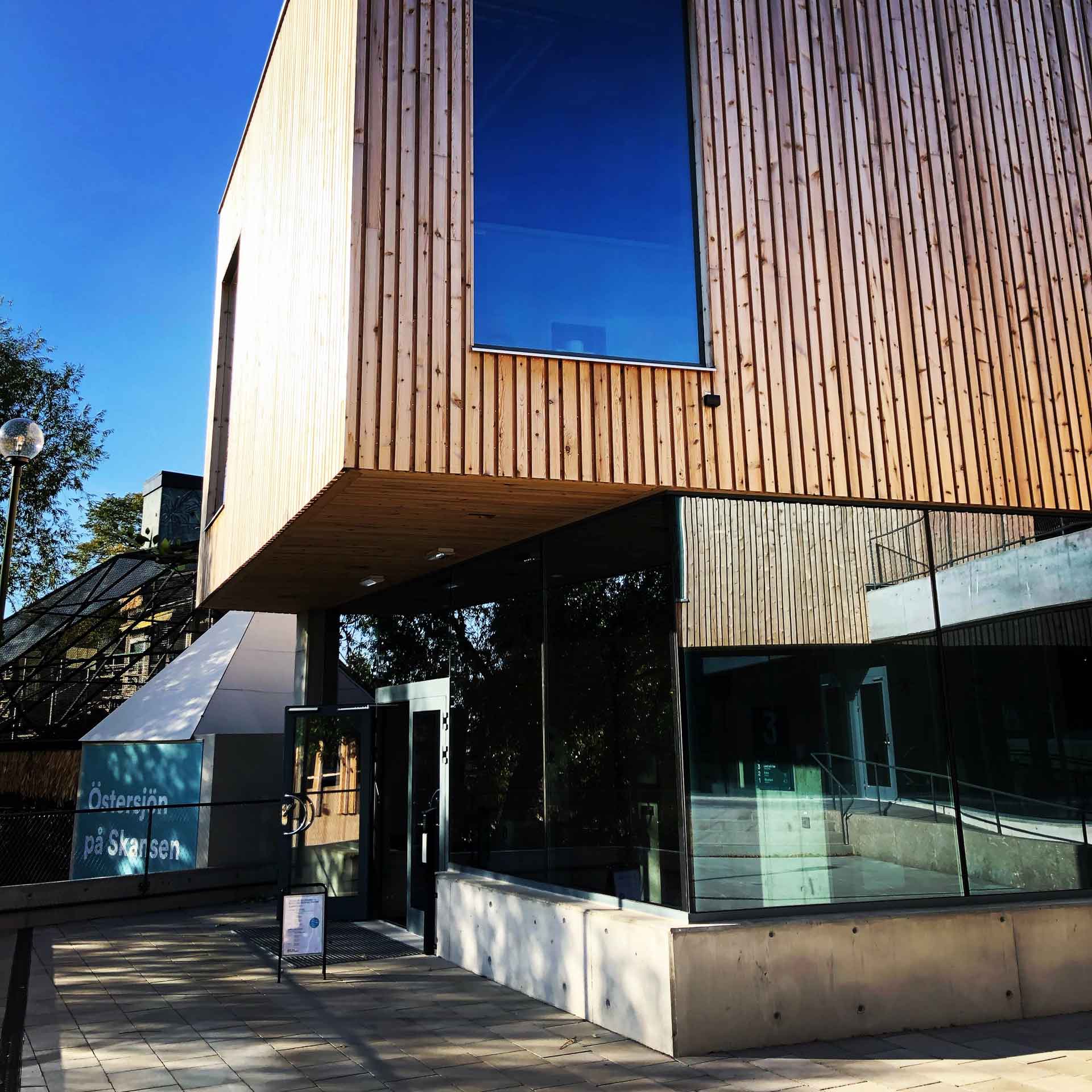 A building with wooden panneling and a concrete base